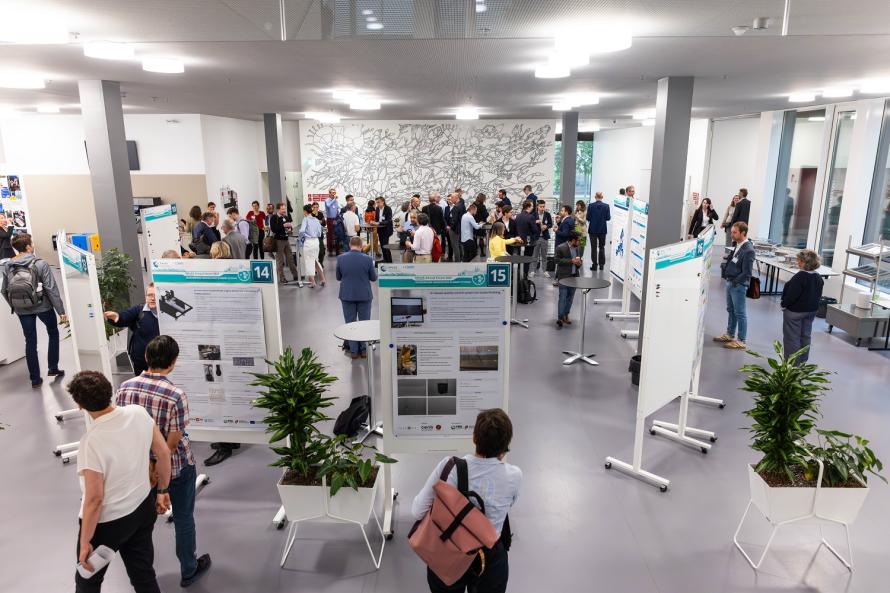 Picture shows people looking at posters 